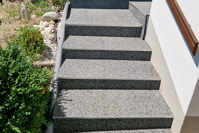grey outside staircase with WARCO stair covering leads past the house Right garden.